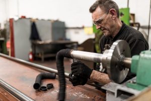 A man doing some manufacturing with rubber